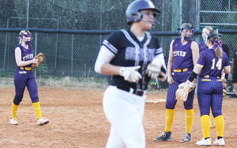Columbia pitcher Harleigh Price gets some encouragement from teammate Alex Collins (14) as Gainesville’s Braylin Cook makes her way around the bases after a home run during Tuesday’s District 2-5A semifinal. (MORGAN MCMULLEN/Lake City Reporter)