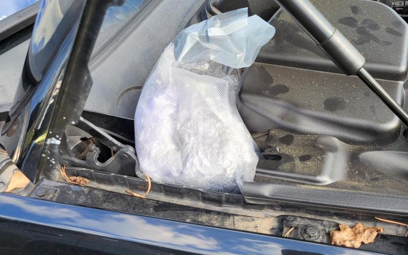 Four pounds of methamphetamine were found beneath the hood of a car pulled over Wednesday on Interstate 75 for a busted windshield. (COURTESY)