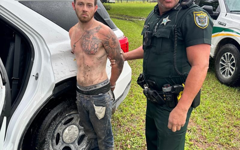 Samuel Sanders is handcuffed by Suwannee County Deputy Derek Slaughter after fleeing from an attempted stop and crashing in a stolen vehicle Wednesday. (COURTESY SCSO)