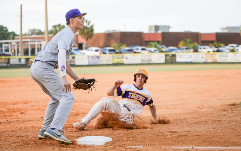 Columbia's Grant Bowers slides safely into third base during Tuesday's District 2-5A semifinal against Gainesville. (BRENT KUYKENDALL/Lake City Reporter)