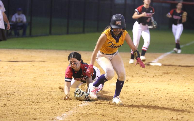 Columbia shortstop Lillyenne Mayhew gets caught in a rundown by Middleburg third baseman Madisyn Strickland in the sixth inning of Thursday's game. (MORGAN MCMULLEN/Lake City Reporter)
