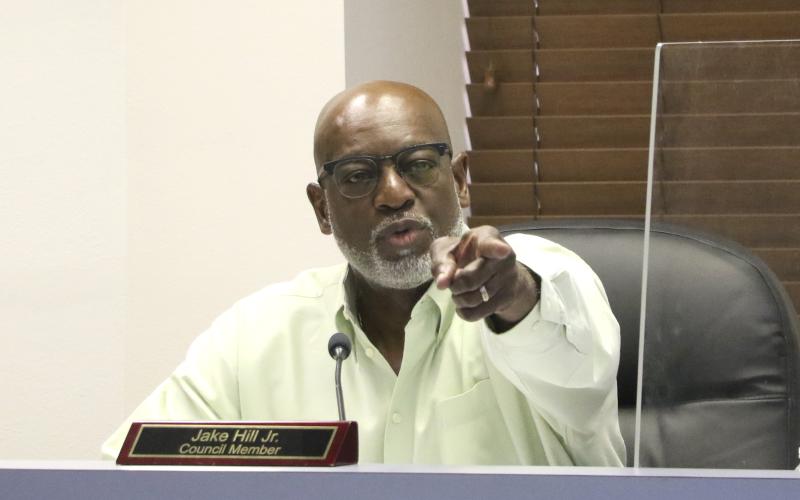 Councilman Jake Hill points toward Glenel Bowden during discussions Monday regarding city council raises. (MORGAN MCMULLEN/Lake City Reporter)