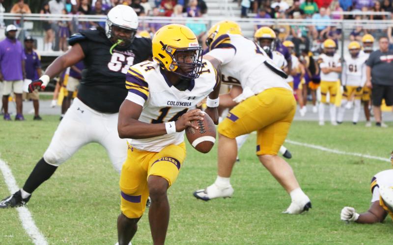 Columbia quarterback Xavier Collins scrambles out of the pocket during Friday’s spring game against Fort White. (MORGAN MCMULLEN/Lake City Reporter)
