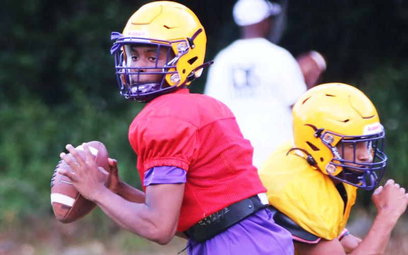 Columbia quarterback Xavier Collins drops back to pass during Wednesday’s practice. (JORDAN KROEGER/Lake City Reporter)