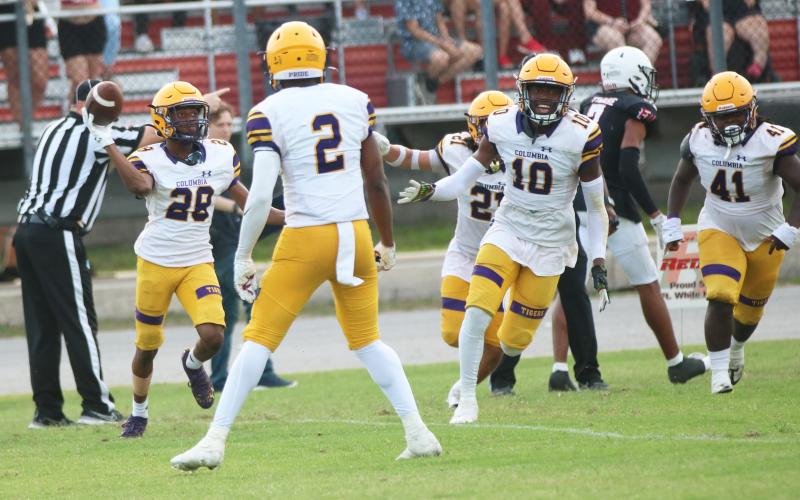 Columbia cornerback Mekah Combs-Turner (28) celebrates with teammates after intercepting a pass against Fort White during their spring game on May 17. (JORDAN KROEGER/Lake City Reporter)
