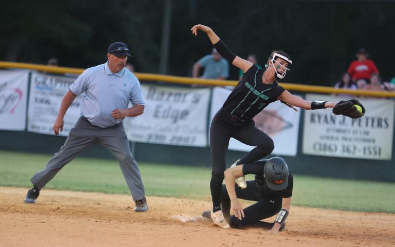 West Nassau’s Lauren Rosepiler beats a throw to Suwannee shortstop Rachel Smith at second base during Wednesday’s Region 1-3A quarterfinal. (PAUL BUCHANAN/Special to the Reporter)