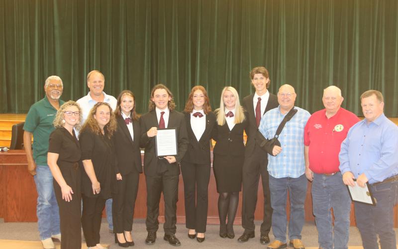 County Commissioners Ron Williams (from left) and Robby Hollingsworth stand with members and advisors for the Fort White High School HOSA parlimentarian team Christan Higginbotham, Ashley Blanton, Kamryn Cembruch, Trace Taylor, Jayda Plasencia, Clara Robinson, Kenton Hassee and Commissioners Rocky Ford, Everett Phillips and Tim Murphy. (TONY BRITT/Lake City Reporter)