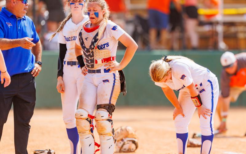 Branford coach Oscar Saavedra and players Madyson Sikes (from left), Morgan Brennan and Laila Arnold show their emotion after losing to Trenton in the Class 1A state championship on Saturday. (JACK HOWDESHELL/Special to the Reporter)