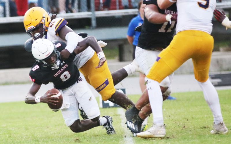 Fort White quarterback Jayden Jackson is sacked by Columbia defensive lineman Terry Henry during Friday’s spring game. (JORDAN KROEGER/Lake City Reporter)