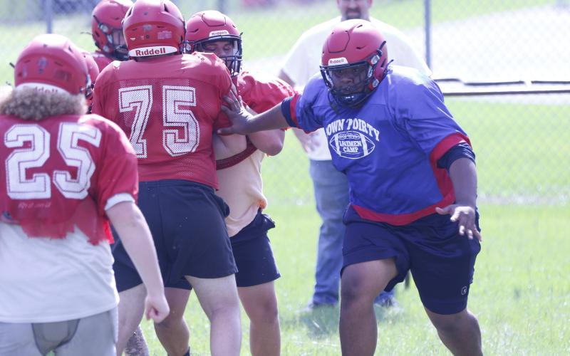 Lafayette offensive lineman Troy Mares performs a run-blocking drill during Monday’s practice. (JAMIE WACHTER/Lake City Reporter)