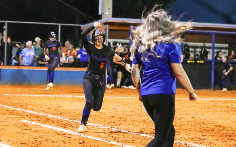 Branford third baseman Madyson Sikes celebrates running to first base after hitting a walk-off home run to defeat Fort White in the Region 3-1A championship on Tuesday. (BRENT KUYKENDALL/Lake City Reporter)