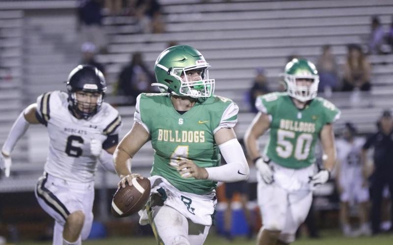 Suwannee quarterback Thomas Sikes looks for a receiver as he rolls out against Buchholz during Thursday's spring jamboree at Langford Stadium. (JAMIE WACHTER/Lake City Reporter)