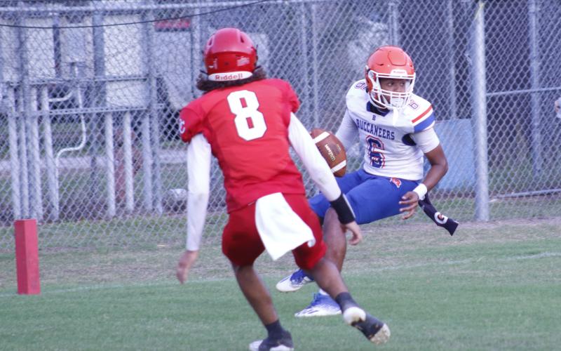 Branford quarterback Damian Herrera is pressured in the end zone by Dixie County’s Curtis Copeland. The play resulted in a safety. (JAMIE WACHTER/Lake City Reporter)