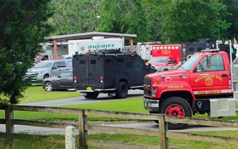 Law enforcement and fire rescue vehicles stage at Gibson Park on Wednesday morning during a standoff at a Hamilton County residence. (JASON WILKINSON/Lake City Reporter)