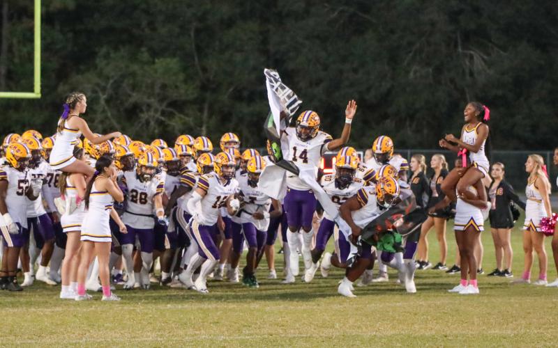Columbia's football team takes the field prior to a game against Ridgeview last season. (BRENT KUYKENDALL/Lake City Reporter)