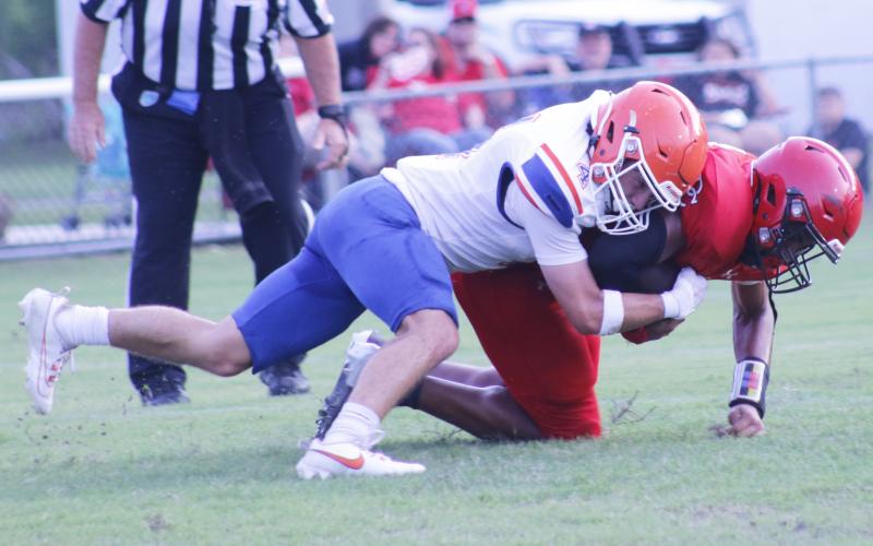 Branford linebacker Troy Roberts makes a tackle against Dixie County during their spring game on May 17. (JAMIE WACHTER/Lake City Reporter)