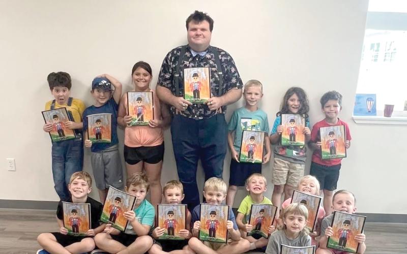 Austin Phelps met with the Lafayette 4-H Cloverbuds during 4-H Fundamentals camp. Phelps showed off skills with a basketball and balloon animals while the Cloverbuds received autographed copies of the the book, ‘The Original Mr. Phelps.’ (COURTESY)