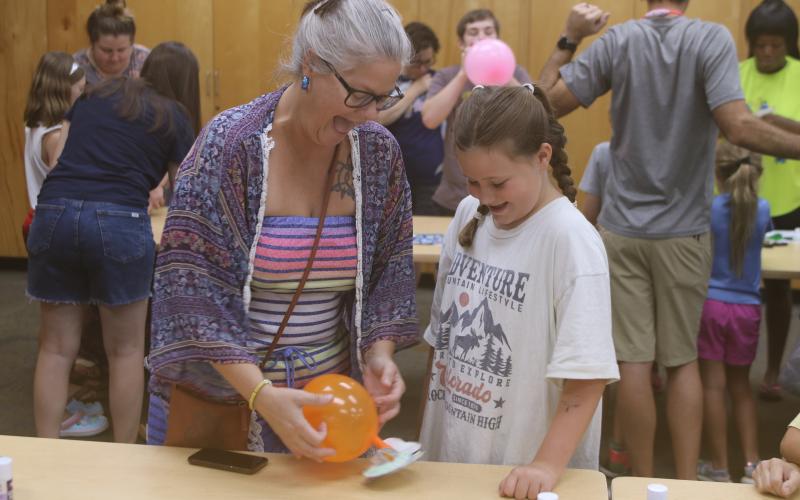 Laura Hicks (from left) and her daughter, Ava Wilson, enjoy testing out their hovercraft experiment at the Columbia County Public Library’s STEAM lab Friday. (TONY BRITT/Lake City Reporter)