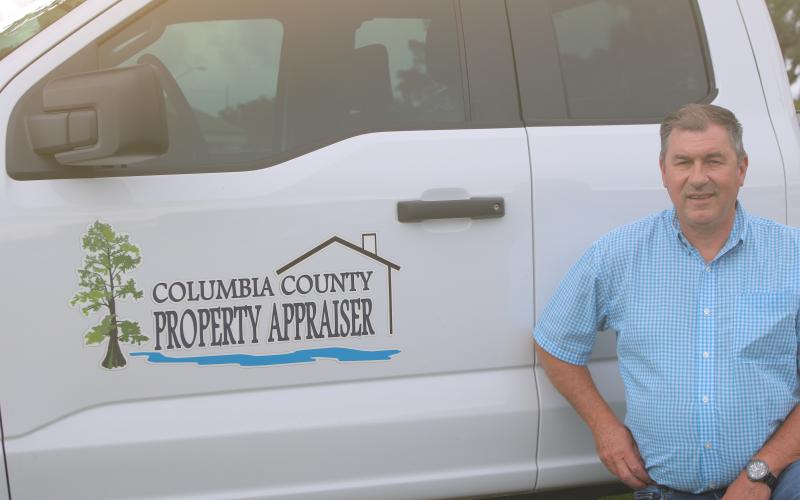 Columbia County Property Appraiser Jeff Hampton shows off the office’s new logo, which has been added to the sides of the employees’ trucks to make them easier to identify. (TONY BRITT/Lake City Reporter)