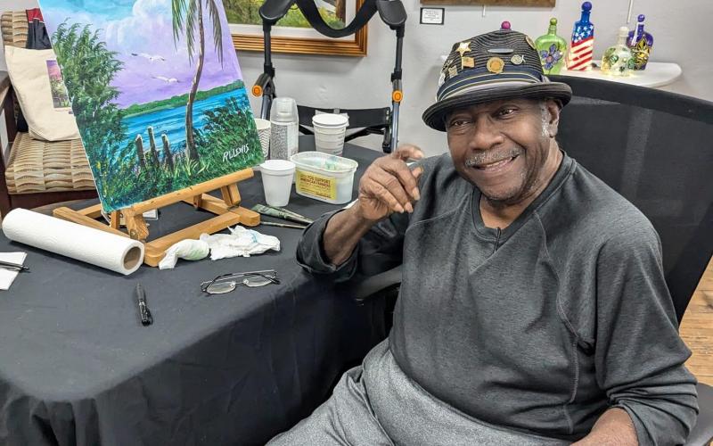 R.L. Lewis, an original Florida Highwaymen artist, demonstrated his artistic style at the Gateway Art Gallery on Saturday. (COURTESY)