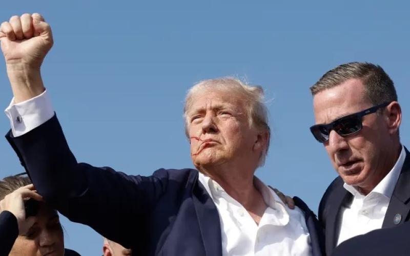 Republican presidential candidate former President Donald Trump pumps his fist as he is rushed offstage during a rally on Saturday in Butler, Pennsylvania. (ANNA MONEYMAKER/Getty Images)
