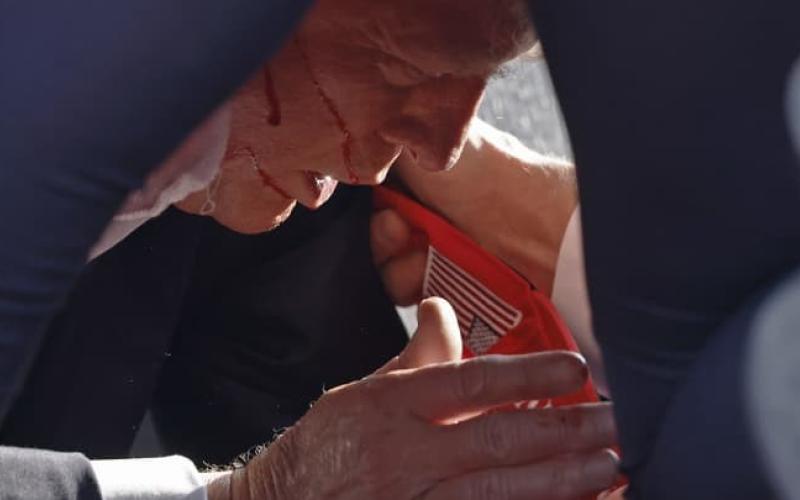 Secret Service tend to Republican presidential candidate former President Donald Trump onstage at a rally on Saturday in Butler, Pennsylvania. (ANNA MONEYMAKER/Getty Images)