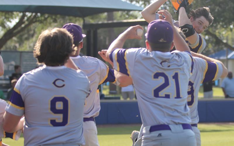 Columbia High’s Ayden Phillips celebrates with teammates after hitting a two-run home run against The Villages Charter this past spring. (FILE)