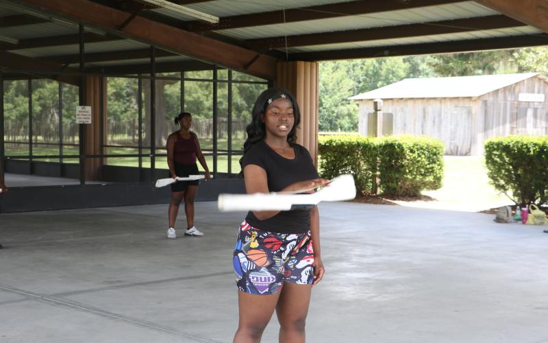 Eri’Yonna Jones, a CHS color guard captain, demonstrates a drop spin at Tuesday’s practice. (MORGAN MCMULLEN/Lake City Reporter)