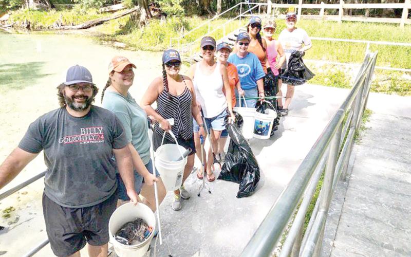 Billy Golightly (from left), Jennifer Golightly, Sandy Kishton, Missy Zecher, Becky Smallwood, Angela Cox, Rhaiza Faulkner, Ginny Smith and Lynda Granoff pose for a photograph after spending time participating in a recent cleanup effort at Rum Island Park. (COURTESY)