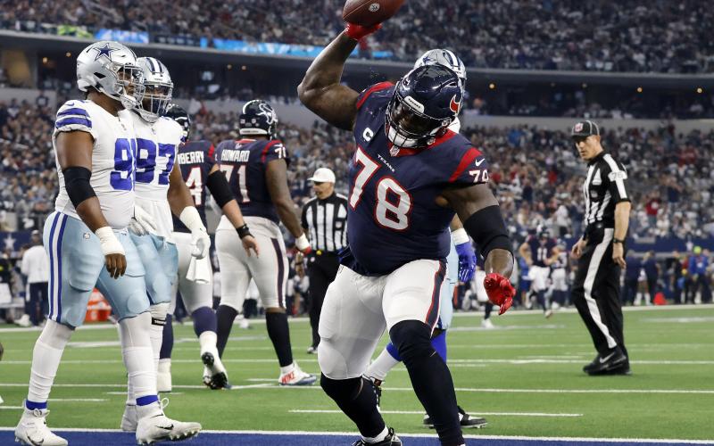 Houston Texans offensive tackle Laremy Tunsil (78) spikes the football after following his team’s touchdown against the Dallas Cowboys at AT&amp;T Stadium on Dec. 11, 2022, in Arlington, Tex. (TOM FOX/TNS)