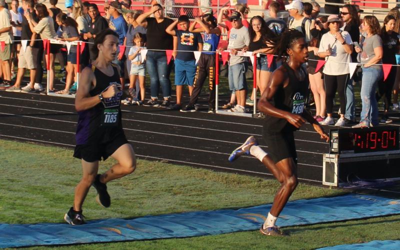 Columbia runner John Ringenberg (left) crosses the finish line to place 55th at the Middleburg Broncos Classic on Saturday. (COURTESY)