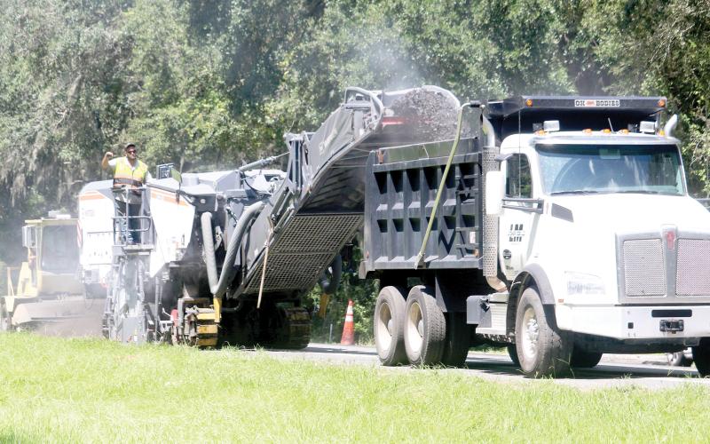 Crews from Anderson Columbia work Wednesday on resurfacing U.S. Highway 41 in southern Columbia County. The first layer of the project is nearly complete but the whole resurfacing and improvements is expected to last until next summer. (TONY BRITT/Lake City Reporter)