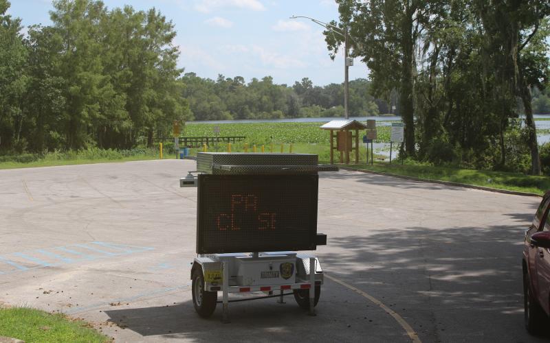 A digital sign sits in the parking lot at Campbell Park and Lake Mongtomery alerting residents that the park will be closed beginning Tuesday for construction of a new fishing pier on the lake. (TONY BRITT/Lake City Reporter)