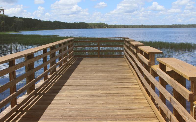 The wooden pier at the Olustee Beach Day Use Area boat ramp in the Osceola National Forest was recently refurbished and rehabilitated, providing a safer environment for fishing. (TONY BRITT/Lake City Reporter)