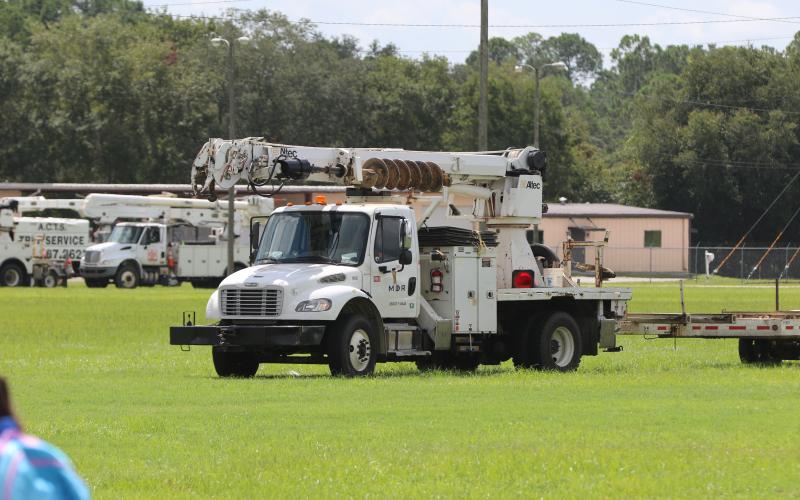 Power trucks staged Saturday at the Florida Gateway Fairgrounds in preparation for Tropical Storm Debby. The trucks, from various companies across the country, will help Florida Power &amp; Light restore power where needed after impact. (JAMIE WACHTER/Lake City Reporter)
