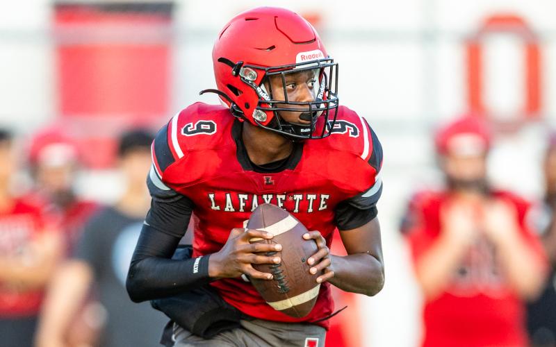 Lafayette quarterback Tywan Williamson rolls out to pass against Tyalor County during the teams’ spring game on May 23. (JACK HOWDESHELL/Special to the Reporter)