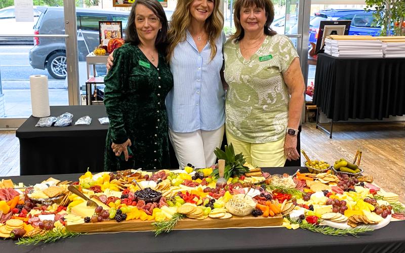 Sheila Carr (from left), curator of the Gateway Art Gallery stands with Abbie Chasteen Rosner, owner of  All Things Abbie, and Jeanne Van Arsdall, chairman of the Gateway Art Gallery’s 10th anniversary celebration and creator of the Charcuterie and Chardonnay fundraiser event. Konnie Patke (not pictured), director of the Tourist Development Agency, was the wine sommelier for the event. (COURTESY)