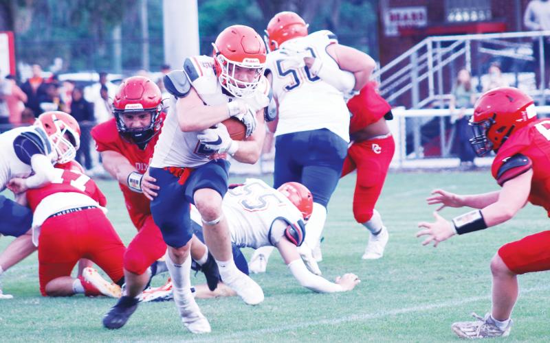 Branford running back Trevor Maddox breaks through a tackle against Dixie County during the teams’ spring game on May 17. (JAMIE WACHTER/Lake City Reporter)