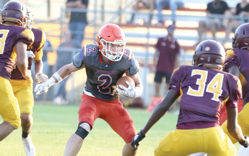 Branford running back Trevor Maddox looks for room to run against Crescent City during a three-team preseason jamboree on Aug. 16. (MORGAN MCMULLEN/Lake City Reporter)