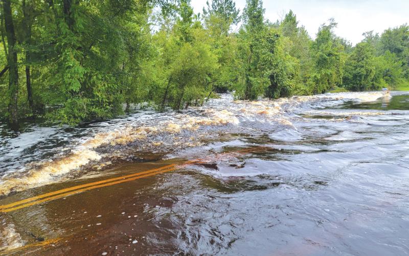 Flood waters rush across Falling Creek Road on Monday after Hurricane Debby passed through. Columbia County Fire Rescue firefighters pulled a woman from a flood vehicle in the waters Monday evening. (COURTESY COLUMBIA COUNTY FIRE RESCUE)