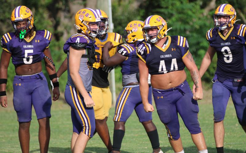 Columbia defensive lineman Caden Bolstein (44) celebrates after making a tackle alongside teammates Jalen Gaskins (5), Ayden Phillips (4) and Kyten Davis (9) during Wednesday’s practice. (JORDAN KROEGER/Lake City Reporter)