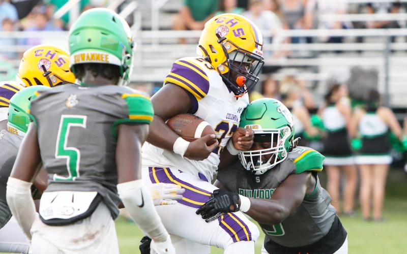 Suwannee linebacker Delwyn Allen dives to tackle Columbia running back Johnathan Andrews during last season’s Preseason Classic. (FILE)