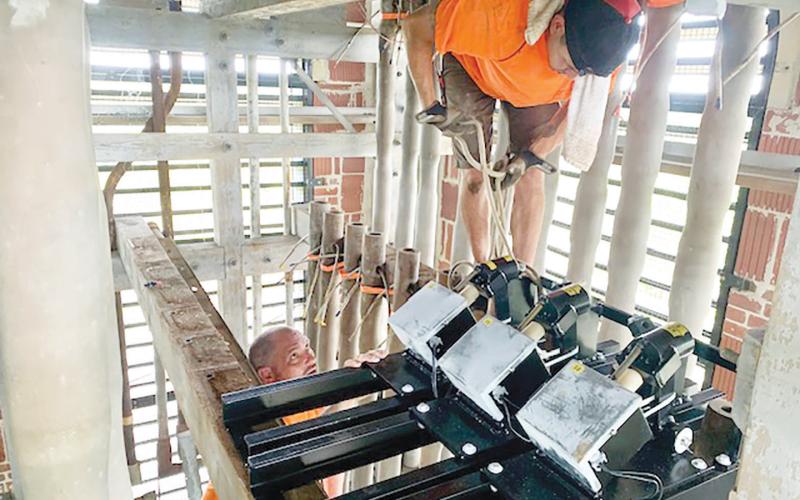 Workers install new bells in the carillon tower at Stephen Foster Folk Culture Center State Park. (COURTESY)