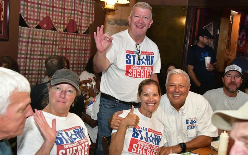 Suwannee County Sheriff Sam St. John (right) was all smiles Tuesday night after defeating challenger Jason Rountree in the primary election for sheriff. St. John was accompanied by Chief Deputy Buddy Williams and his wife, Tori St. John. (ROB WOLFE/Lake City Reporter)