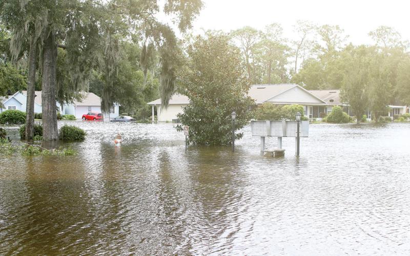Homes in the Tara Trace subdivision in Live Oak are surrounded by water as the neighborhood is flooded following Hurricane Debby. (TONY BRITT/Lake City Reporter)