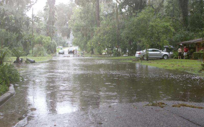 Flood waters cross over SE Inglewood Avenue in Lake City on Monday afternoon after Hurricane Debby dumped up to 16 inches of rain on the area. (TONY BRITT/Lake City Reporter)
