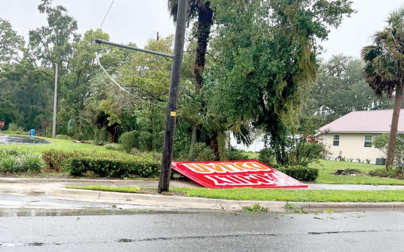 A Family Dollar sign was blown down onto the sidewalk along U.S. Highway 27 in Mayo during Hurricane Debby on Monday. (COURTESY)