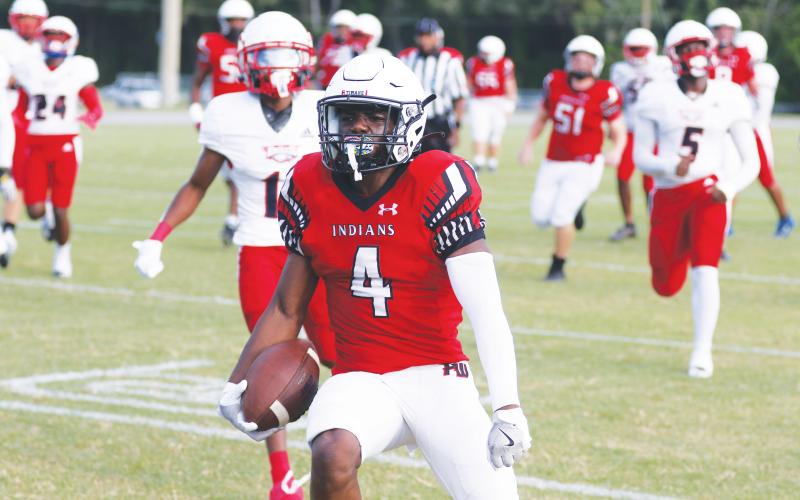 Fort White running back Keimarion Neal celebrates as he scores a touchdown against NFEI during their Preseason Classic on Aug. 15. Neal transferred from Santa Fe and will be Fort White’s starting running back this season. (MORGAN MCMULLEN/Lake City Reporter)