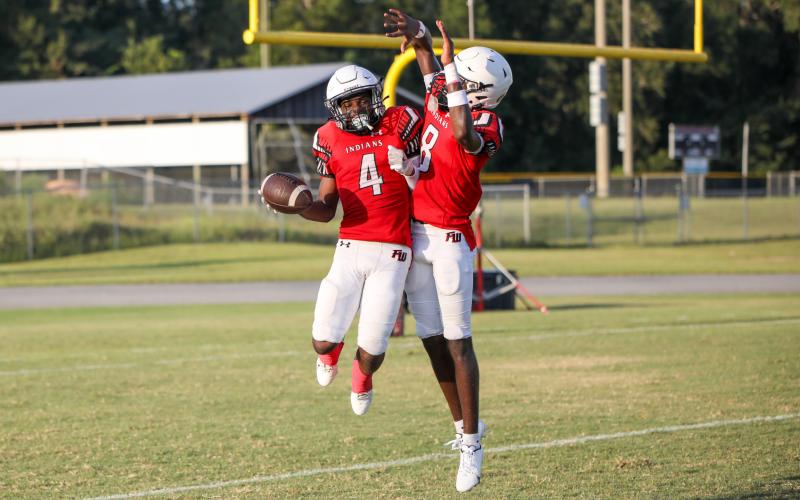 Fort White running back Keimarion Neal celebrates with quarterback Jayden Jackson after scoring a touchdown against NFEI during their Preseason Classic on Aug 15. (BRENT KUYKENDALL/Lake City Reporter)
