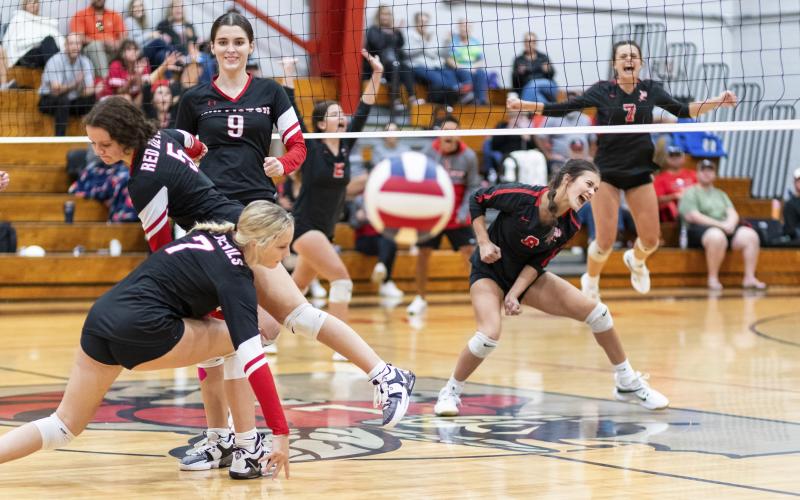 Lafayette senior Kiley Beach (8) reacts to her block of Williston middle hitter Kai Gowland (9) during Thursday's match. (JACK HOWDESHELL/Lake City Reporter)